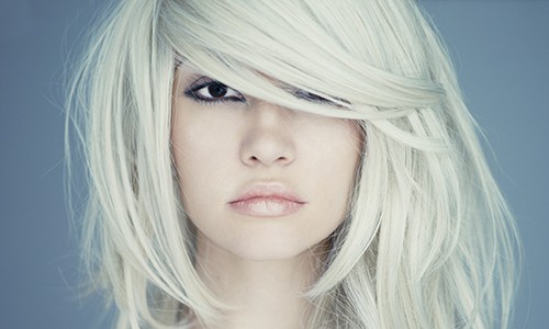 Woman with white blonde hair covering eyes