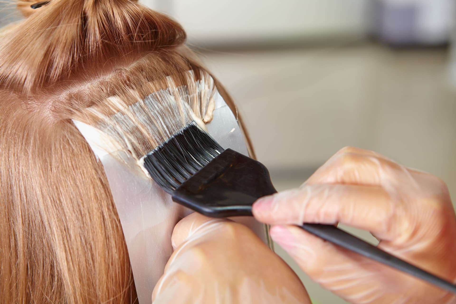 Woman in salon getting hair coloured