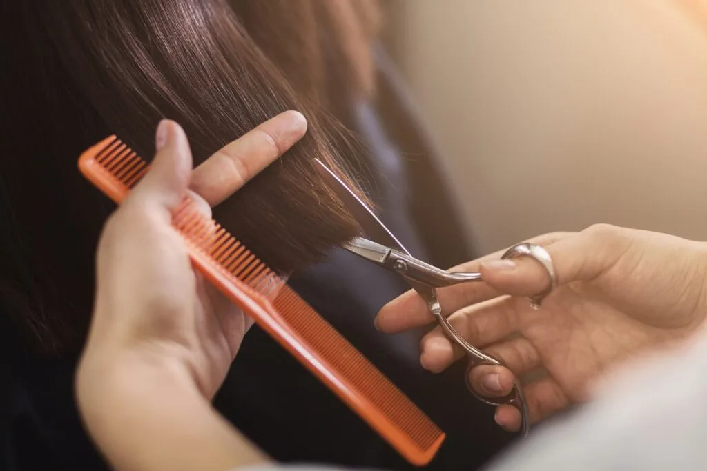 Closeup of woman in salon getting hair cut