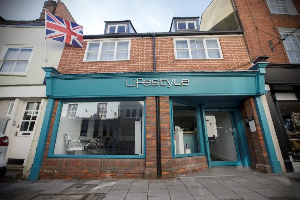 Wide angle outside shot of Lifestyle Salon Aylesbury, company sign on green background