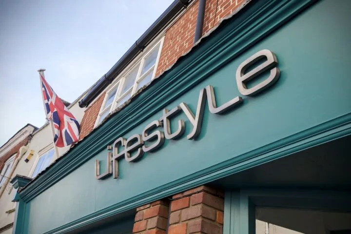Close-up outside shot of Lifestyle Salon Aylesbury, company sign on green background