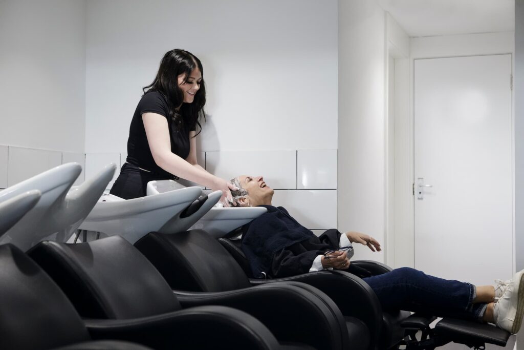 Inside Lifestyle salon Aylesbury with client getting hair washed and smiling
