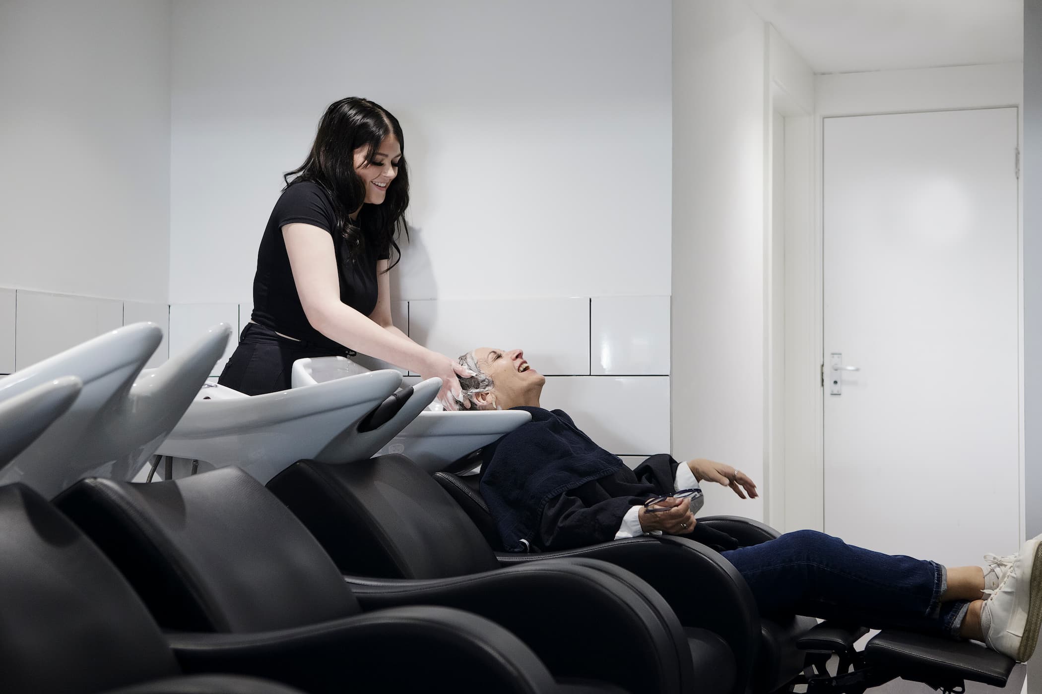 Inside Lifestyle salon Aylesbury with client getting hair washed and smiling