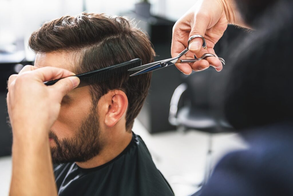 Man in salon having hair cut