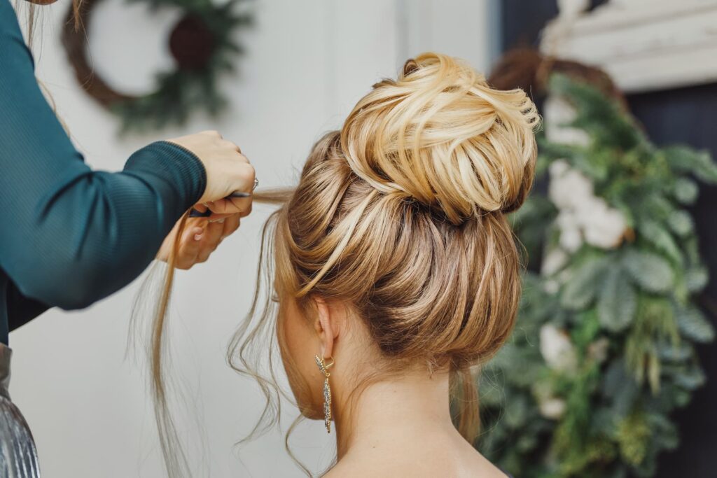 Woman in salon having wedding hair styled